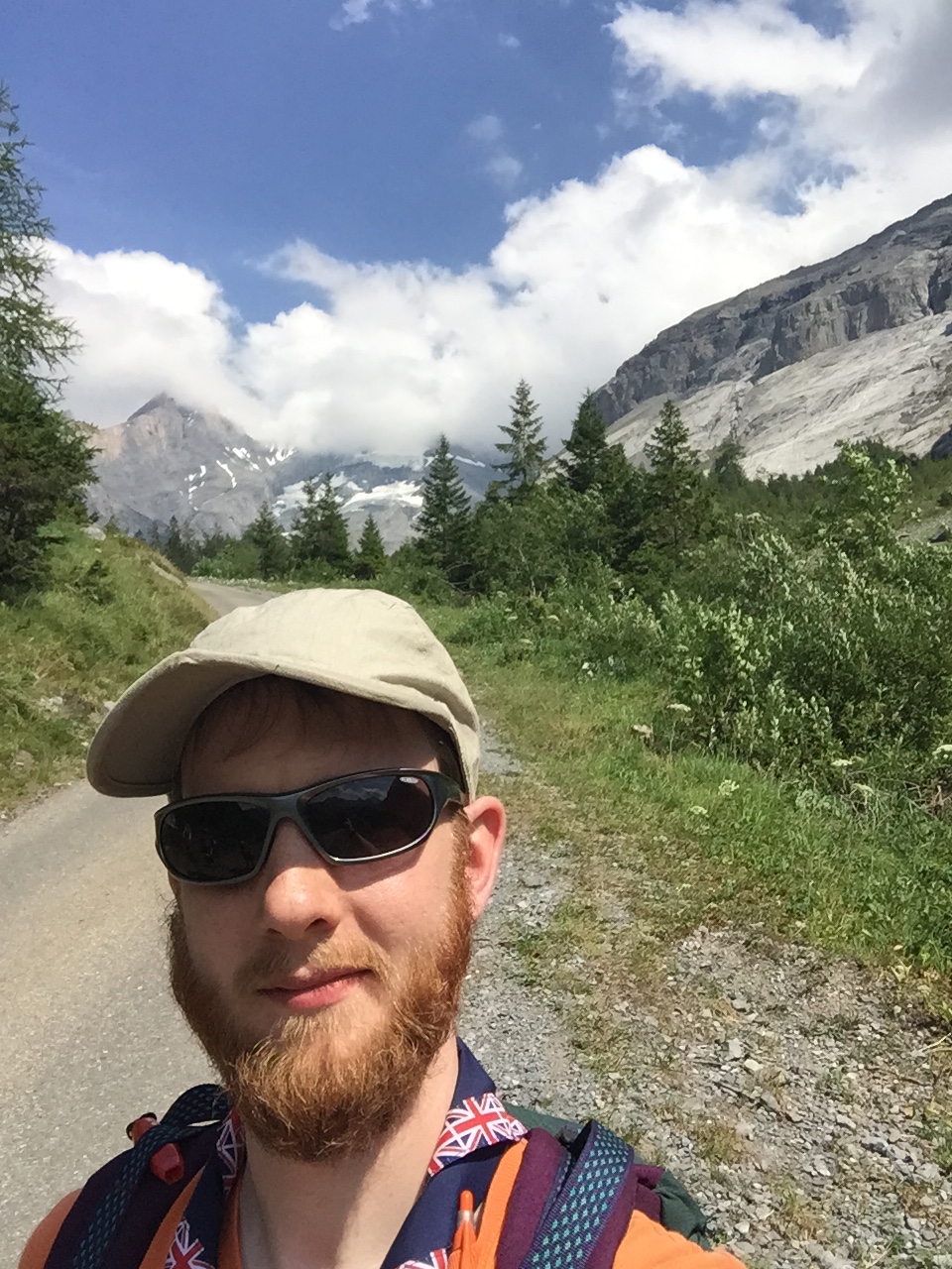 A photo of Phill with a sloping mountain in the background.