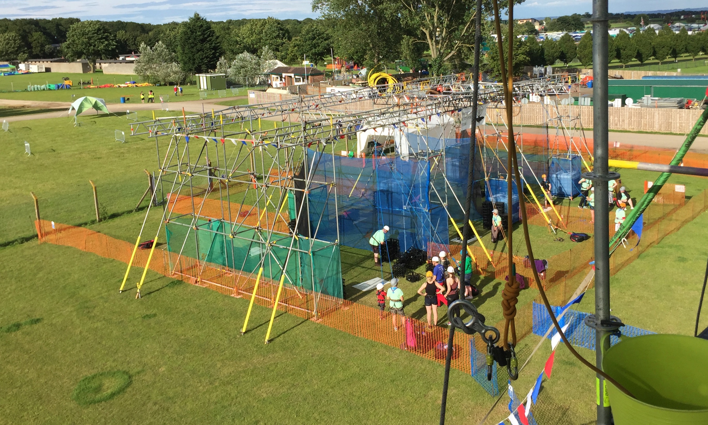 Abseil ropes ready for a participant, with a scaffold crate stacking tower in the background.
