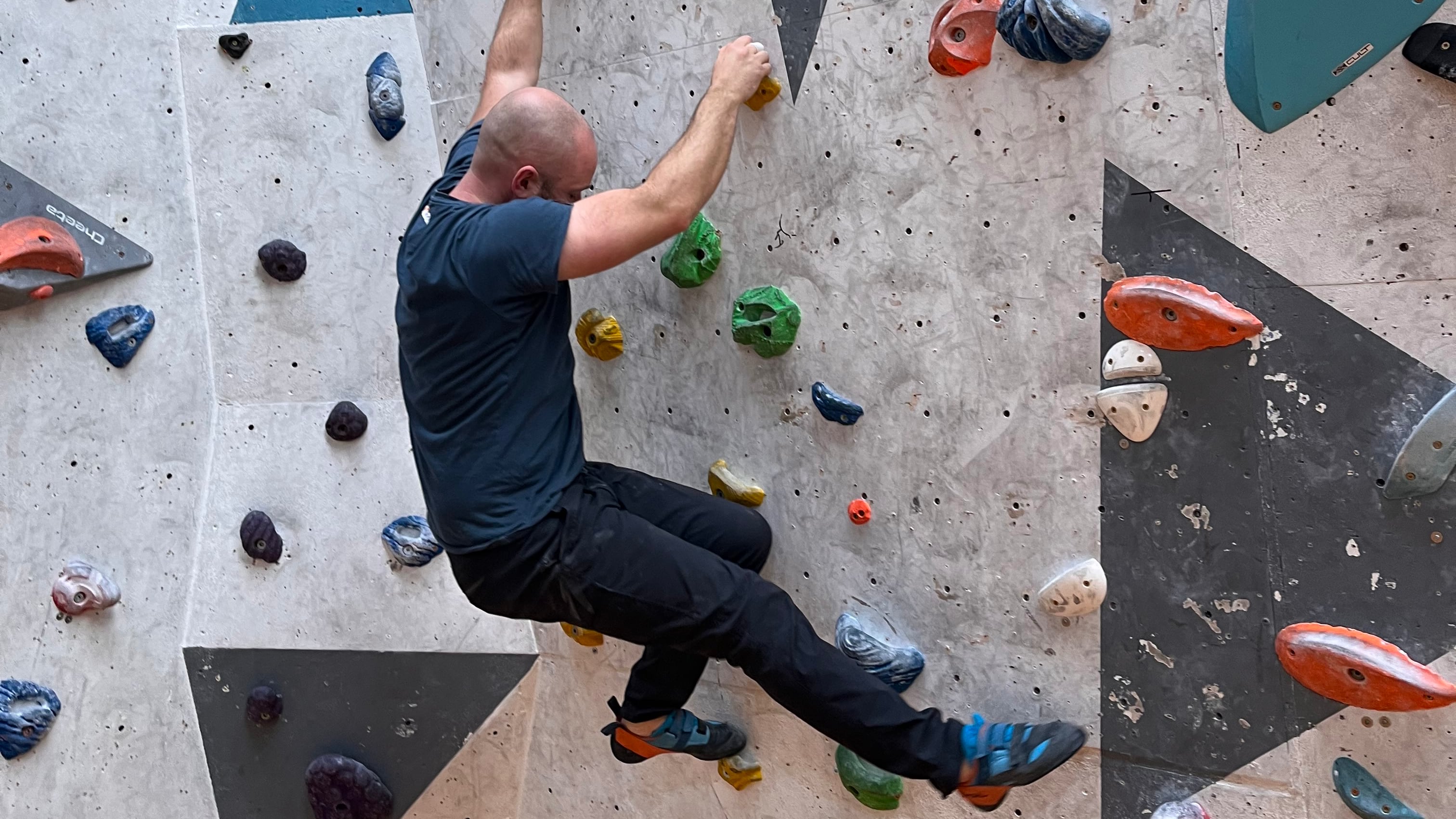 A climber receiving movement feedback on an indoor wall.